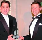 Richard Rohman (right) receives the award from Warren Thompson, MD of Fleet Africa, one of the sponsors of the awards